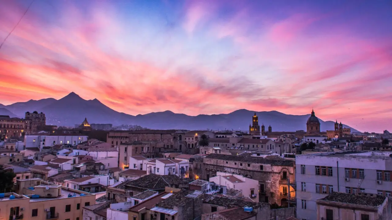 Panoramic view of Palermo at sunset, with the mountain in the background
